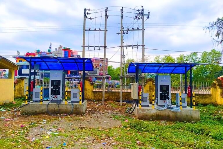 Two electric vehicle charging stations outdoors.