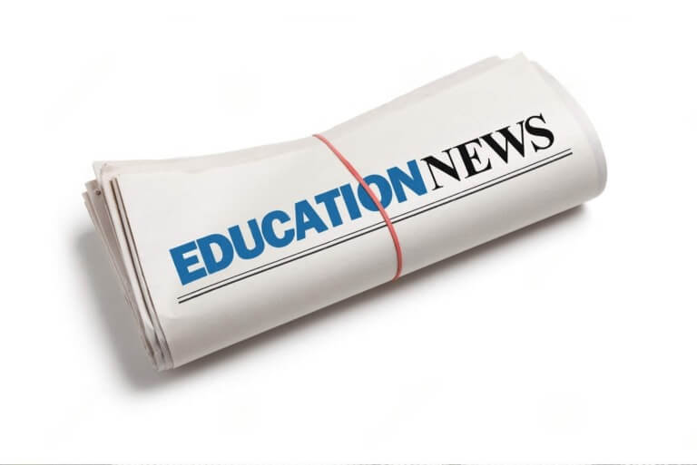 Rolled newspaper with "Education News" headline.