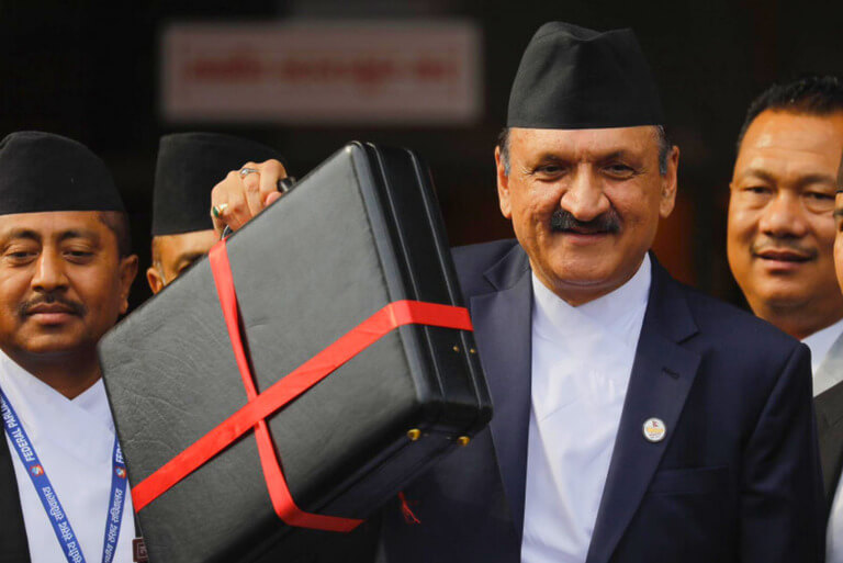 Man holding a black briefcase with a red ribbon.