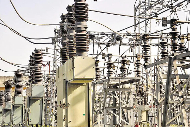 Electricity substation with transformers and high voltage lines.