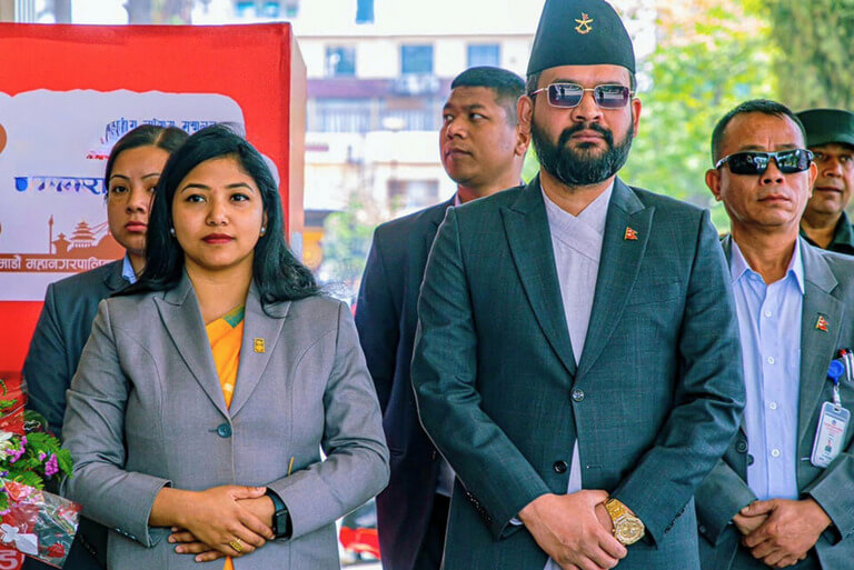 Group of professionals in formal attire outdoors.
