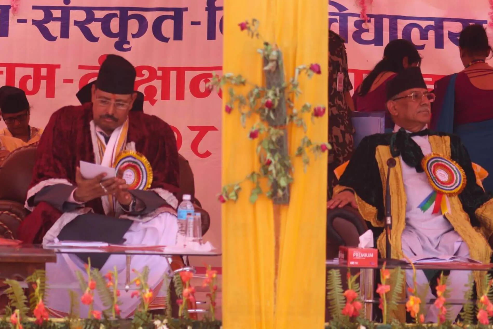 Ceremony attendees in traditional attire, vibrant decoration