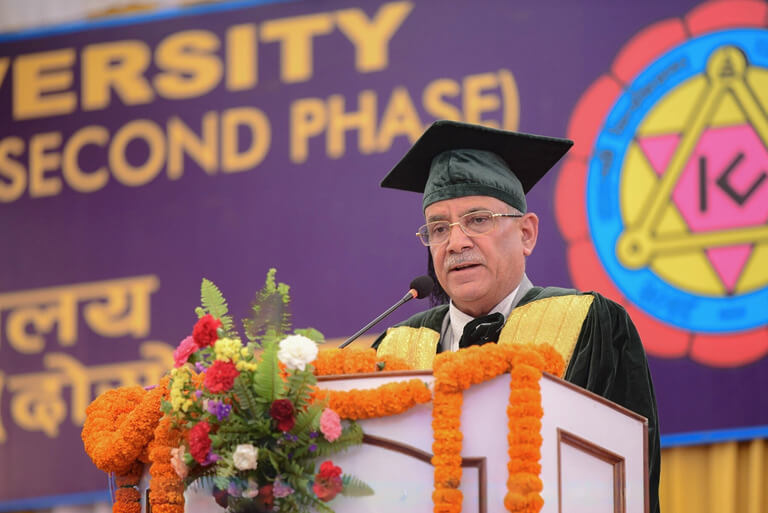 University speech by man in graduation cap and gown.