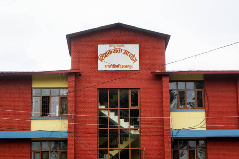 Red brick building with Nepali sign, Bhaktapur.