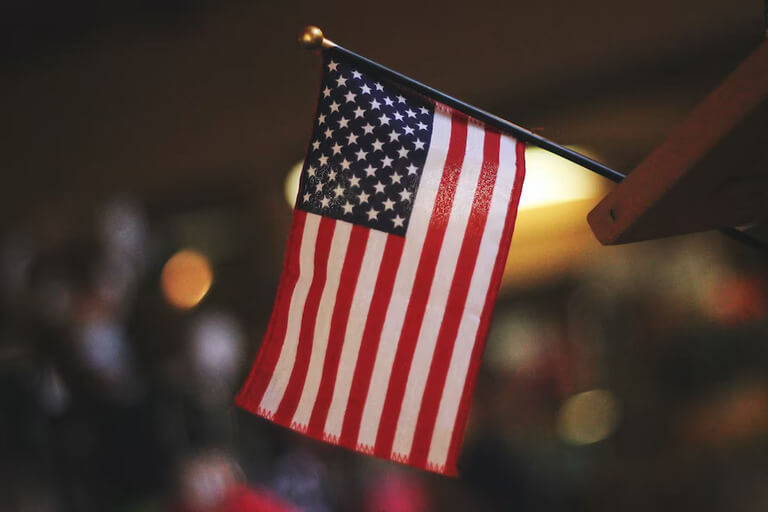 Small American flag indoors, stars and stripes.