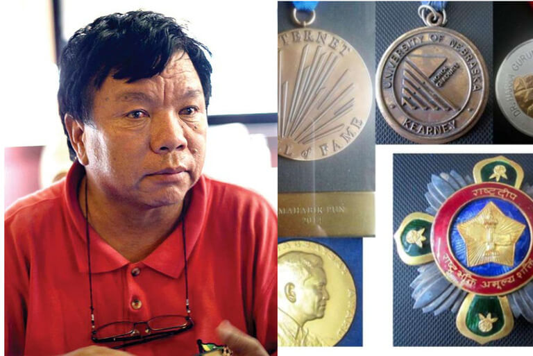 Man with awards and medals for achievements.