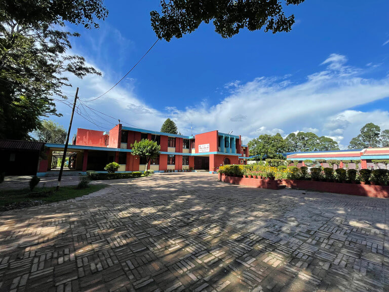 Colorful school building with bright blue sky.