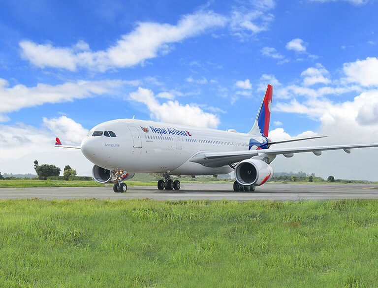 Nepal Airlines plane on runway under blue sky