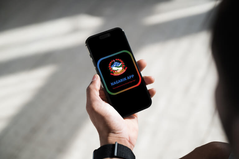 Person holding smartphone with Nagarik app logo.