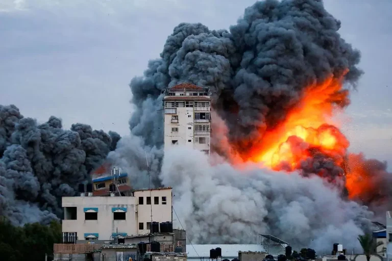 Building explosion with flames and smoke in urban area.