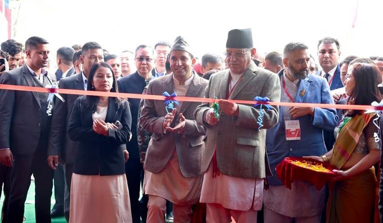 Group cutting ribbon at an event opening ceremony.