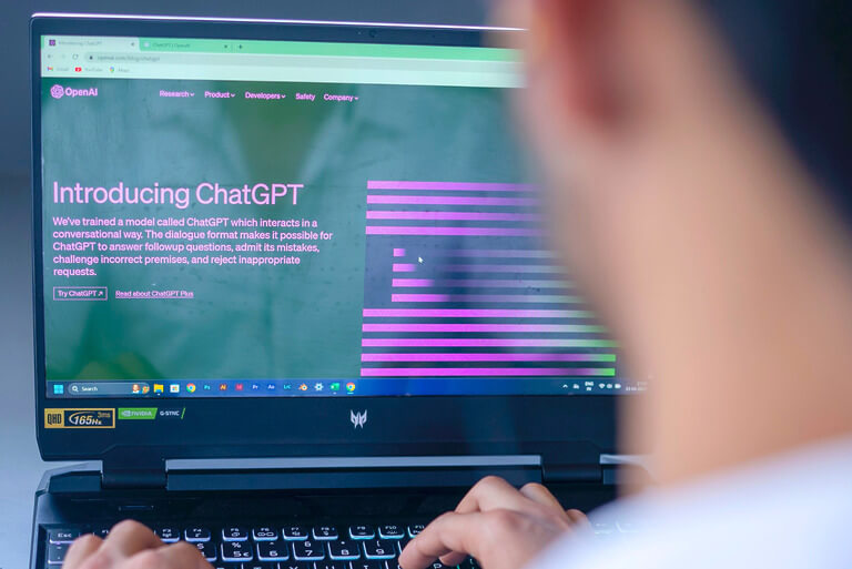 Person using ChatGPT on a laptop screen.