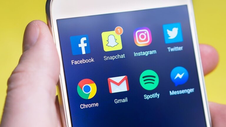 Smartphone displaying popular social media apps on its screen.