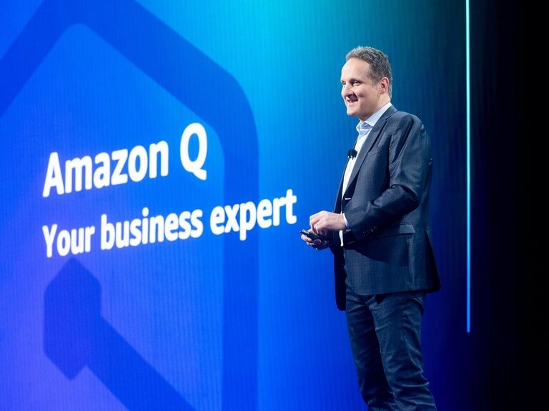 Businessman speaking at Amazon Q presentation event.