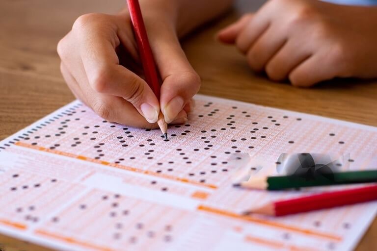 Person filling out a multiple-choice exam sheet.