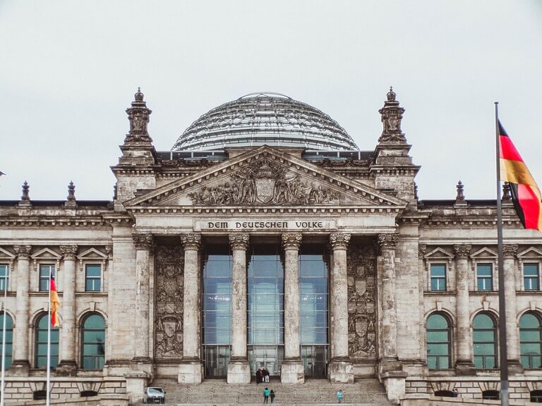 Reichstag building in Berlin, Germany with flags.