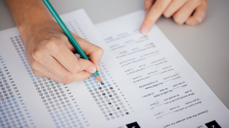 Student filling out a multiple-choice test sheet