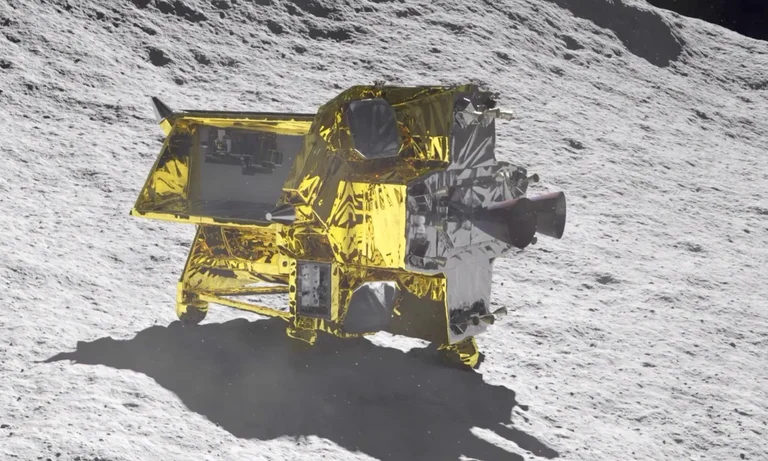 Lunar lander covered in reflective foil on gray lunar surface.