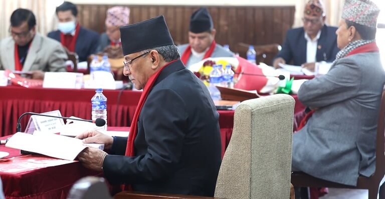 Nepali officials in traditional attire in a conference meeting.